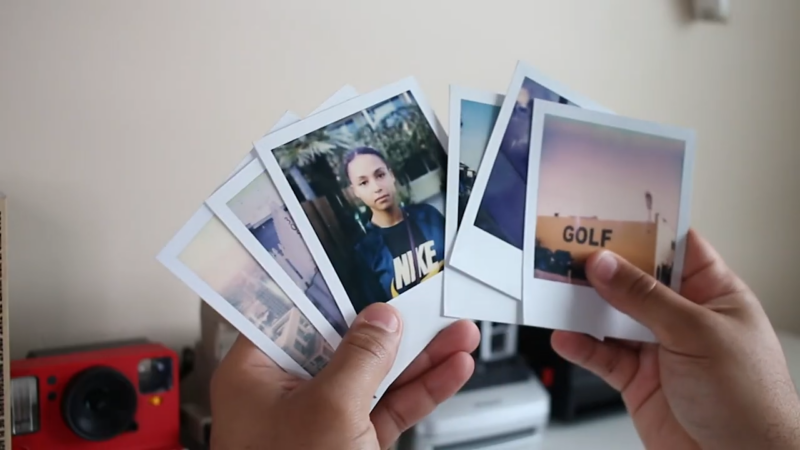 A Person Holding a Few Polaroid Photos